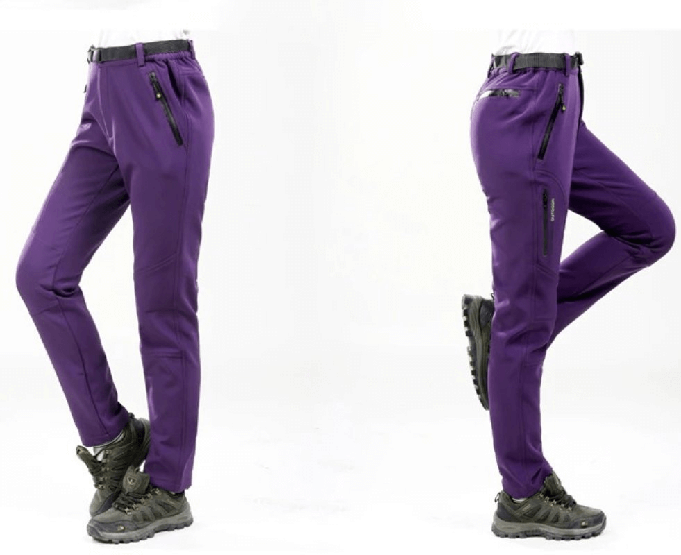 Windproof waterproof fleece women's hiking pants in vibrant purple with zipper pockets, showcasing stylish outdoor adventure gear.